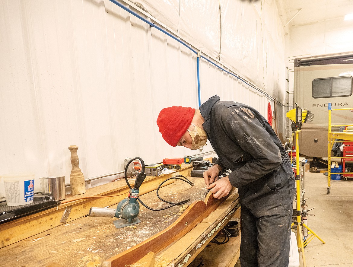 Sam Wagner works on the mustache trim for the Sinopah recently at the Glacier Park Boat Company shop in Columbia Falls. (Chris Peterson photo)