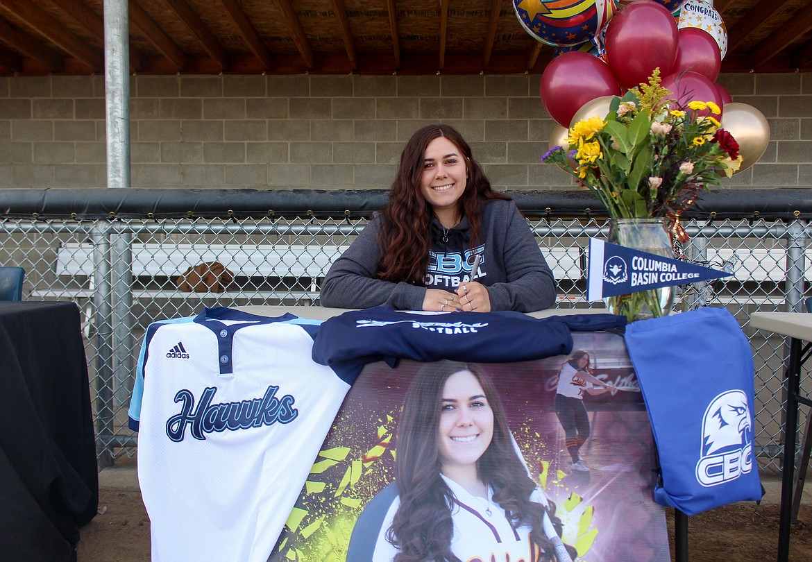 Moses Lake's Harley Raymond signed to play for Columbia Basin College on Wednesday afternoon at Moses Lake High School beside future/current teammate Madi Olson.