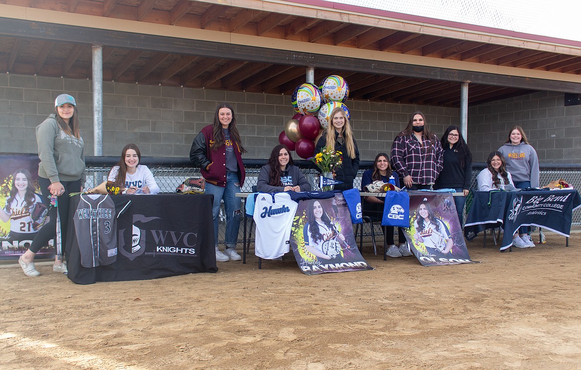 Seated left to right, Ciarrah Knoll, Harley Raymond, Madi Olson and Laurissa Martinez were joined by teammates and family to help celebrate their signings on Wednesday afternoon at MLHS.