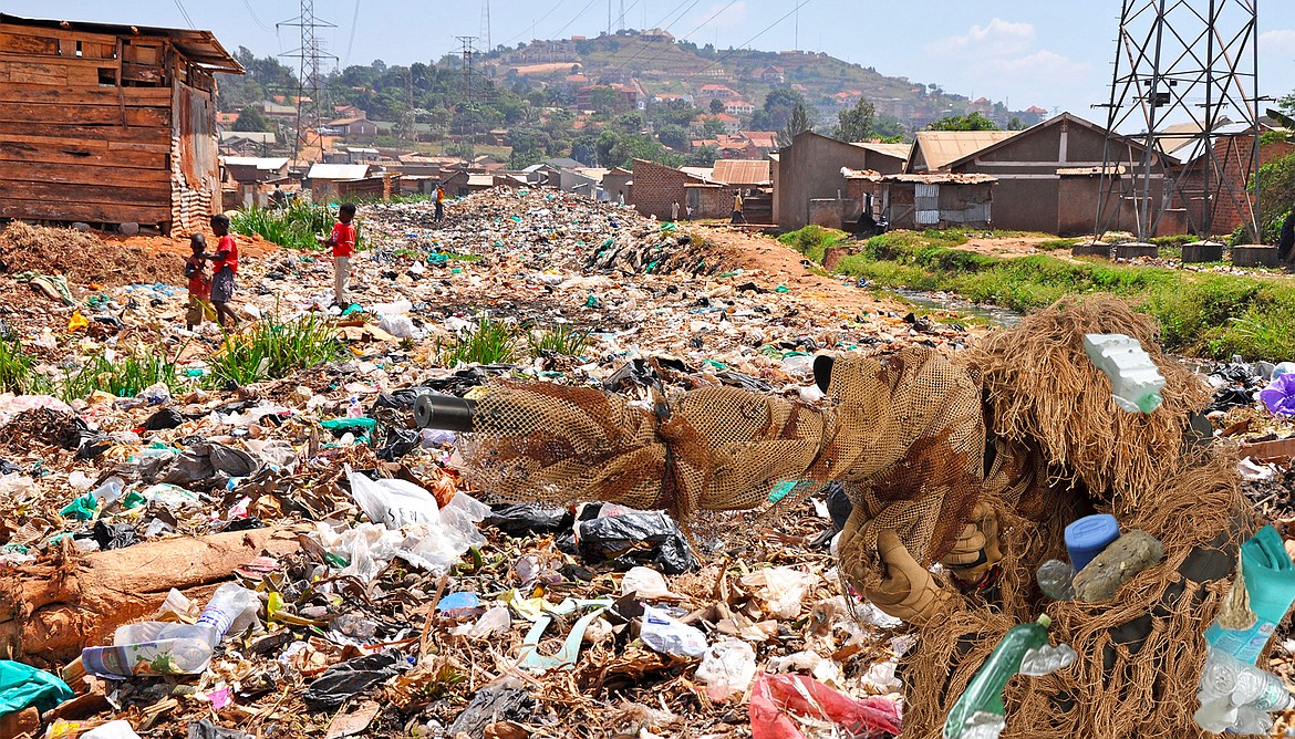 U.S. Navy Seal snipers camouflaged in trash dump.