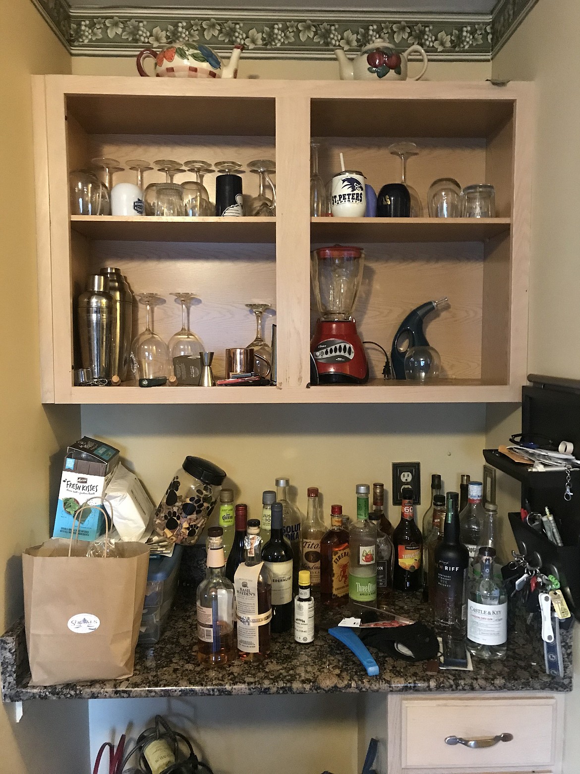 The before picture of Amy Bertrand s bar. Amy Bertrand turned a planning desk into a bar area by removing the doors on the cabinet, painting the interiors blue, adding a backsplash, and installing lights that change colors.