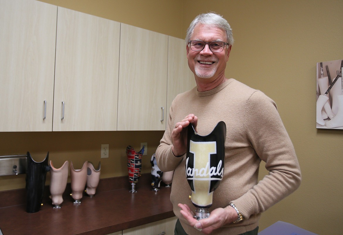 Recently retired prosthetist and orthotist Bob Miller shows off a University of Idaho prosthetic at Kootenai Prosthetics and Orthotics in Post Falls on Friday. Through the 23 years Miller owned the clinic, he made countless lifelong friends and oversaw more than 2,350 prostheses.