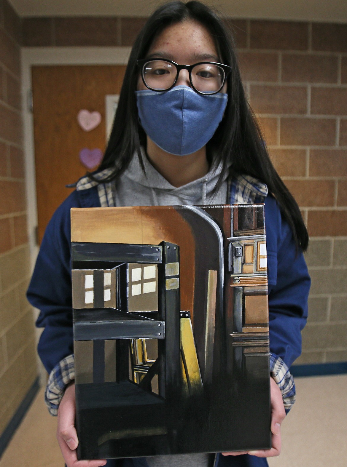 A normal garage scene becomes something wondrous when Heidi Pham gets ahold of it. The Lake City High senior painted this after snapping a film photo and finding something beautiful in the composition. She's seen here Tuesday.