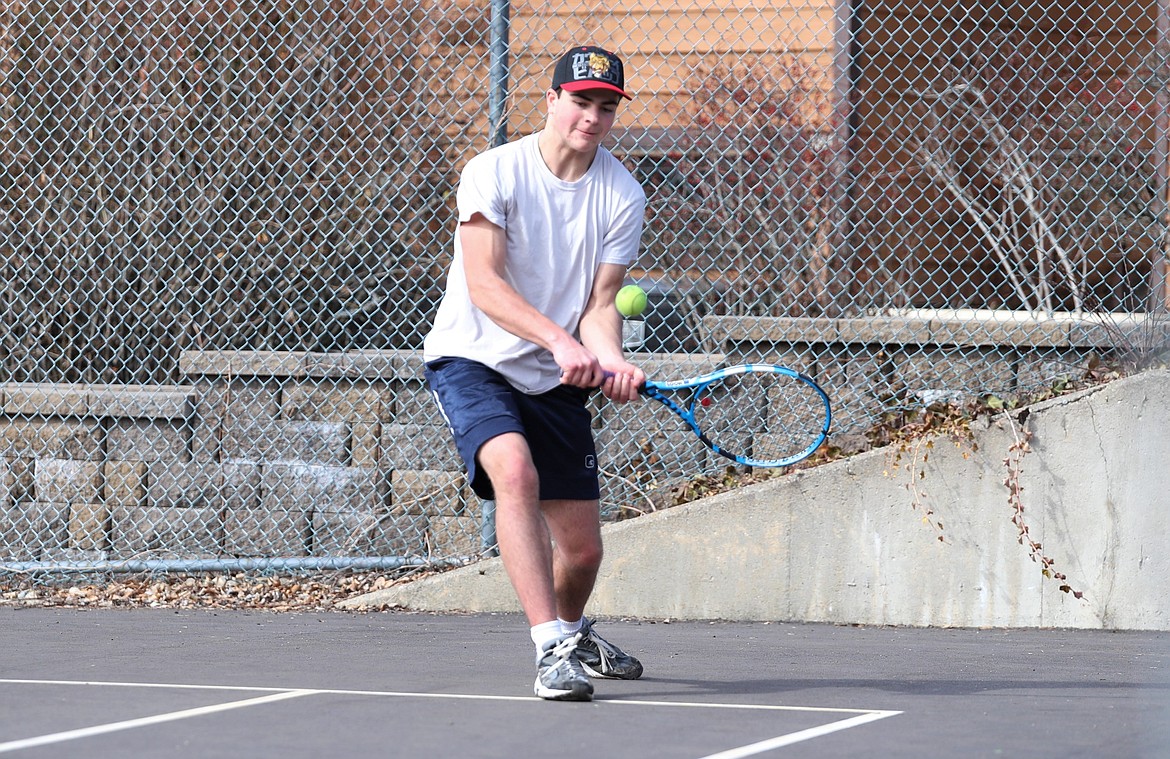 Blaine Williams prepares to hit a backhand down the line during practice on March 18 at the Pend Oreille Shores Resort tennis court.