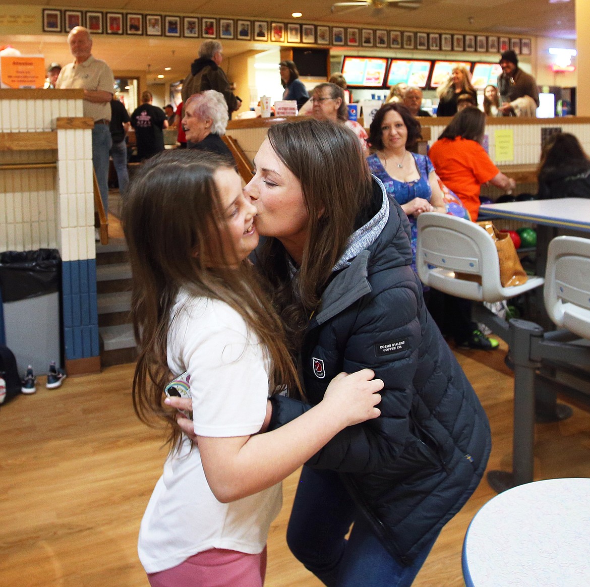 Heather Gallegos hugs her daughter, Rosy, after the 9-year-old took an honorary opening throw of the Idaho state women's bowling tournament at Sunset Bowling Center on Saturday.