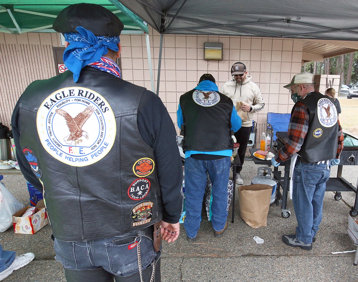 Members of the Eagle Riders serve up free meals to truckers on Saturday in Huetter.