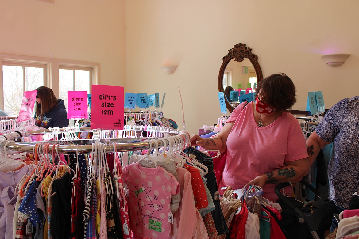 Foster parent Carol Johns shops at the Rhea Lana's consignment event at 605 E. Nelson Road in Moses Lake on Sunday.