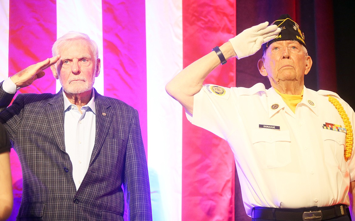 Dick Rutan, left, and Hal Donahue salute during the Kootenai County Republican Central Committee's Lincoln Day Dinner Saturday at The Coeur d'Alene Resort.