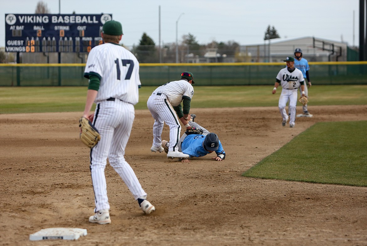 Big Bend third baseman Zach Valdez tags the Spokane runner after he got caught in between second and third base in the second game of the afternoon for the Vikings on Saturday.