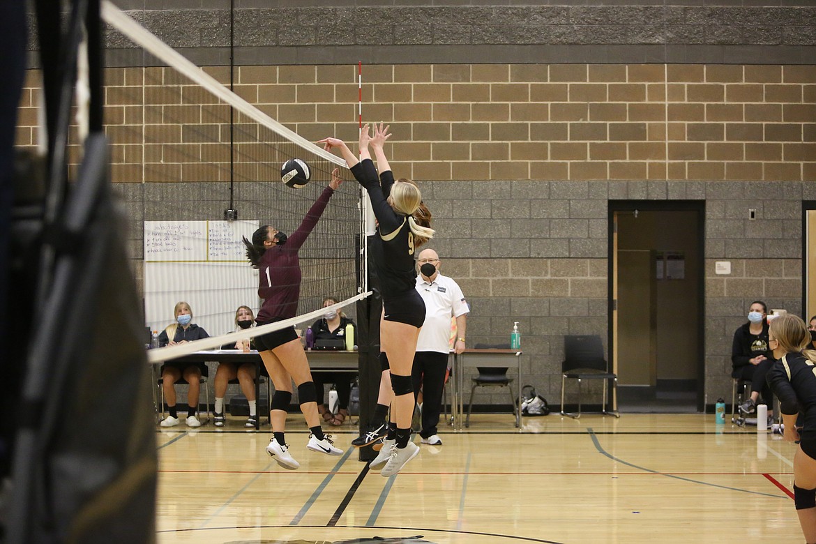 A pair of Royal players go up for the block against Wahluke's Glendy Corrales in the final set of the match on Saturday afternoon at Royal Intermediate School.