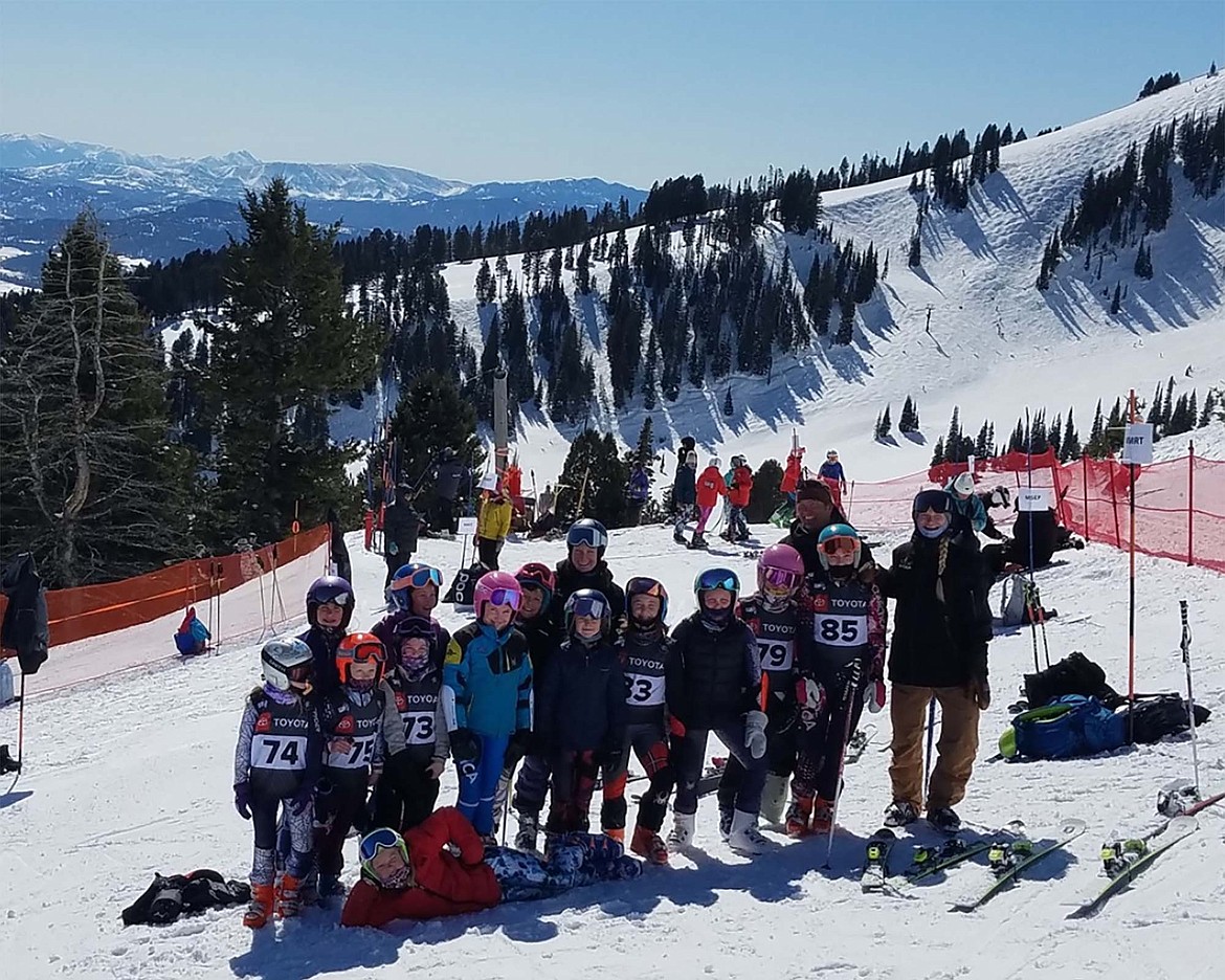FVSEF racers and coaches at the Northern Division YSL Championships at Bridger Bowl. From left to right, Lucy Love, Hazel Remley, Madeline Burton, Lola Zinser, Kira Paatalo, Dynalea Thomblin, Asylin Johnson, Lillie Groom, Liesl Brust and Sidney McPhie, and Piper Marbarger laying in front. In the back row are coaches Madeline Williams, Tommy Hoover and Erika Florian. (Photo courtesy of Madeline Williams)