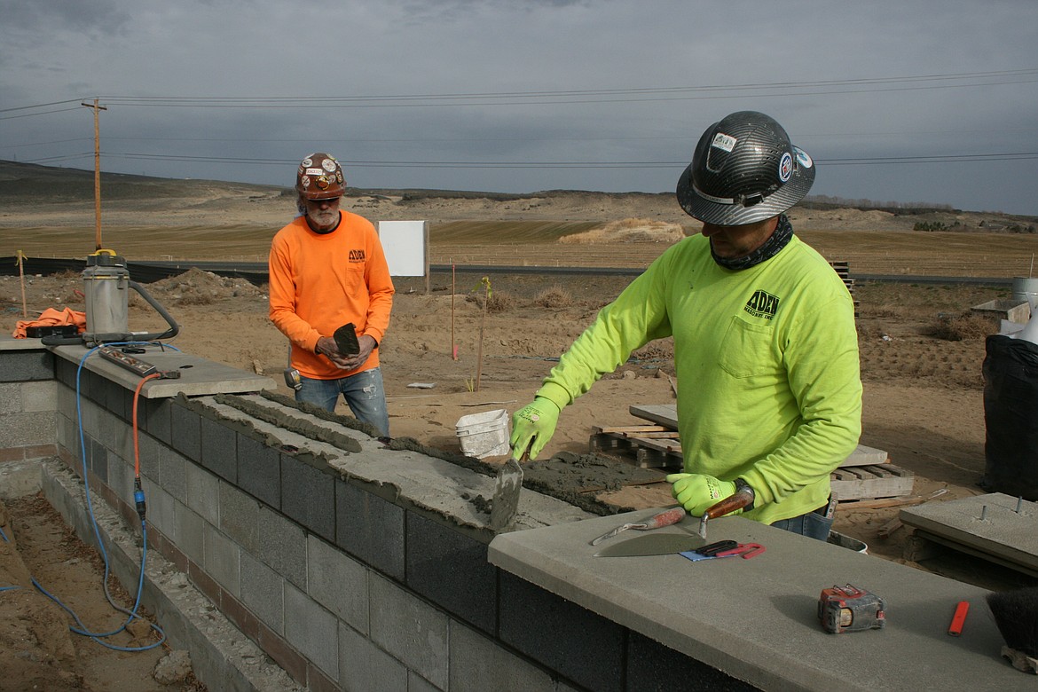 Mason Matt Chilton (left) and Jeff Lacey work on the new Grant County Fire District No. 8 fire hall.
