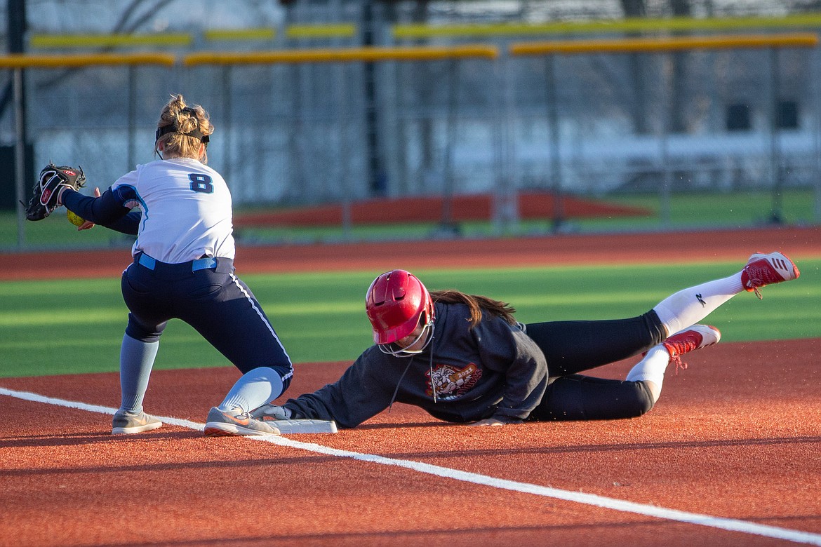 Kaylee Brackett slides headfirst into third base on Tuesday.