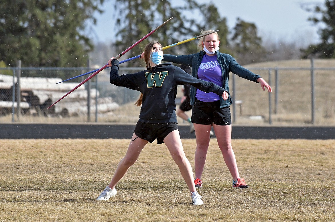 Whitefish's Nayvee Miller (front) and Ainsley Scott work on their javelin technique during practice on Monday at WHS. (Whitney England/Whitefish Pilot)