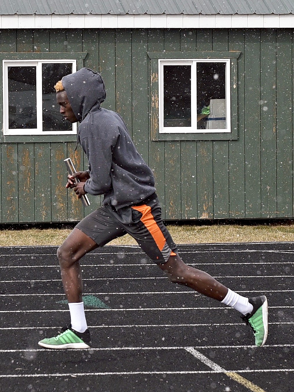 Whitefish senior Marvin Kimera runs during a relay drill at practice on Monday at WHS. (Whitney England/Whitefish Pilot)