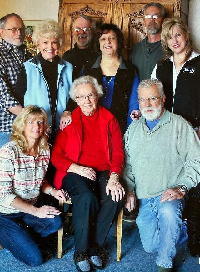 Dr. Steve Brisbois kneels next to his mom, Betty Lundy Evans, in this family photo. Evans died last August, but not before contributing her story to their family history using the services of public historian Sara Jane Ruggles and Auburn Crest Hospice. Pictured, from left, front row: Steve's wife Deanna Brisbois, Evans and Steve. Back row, from left: Evans' daughter Judy Sanborn with husband Glenn; Evans' daughter Jan Stuppy with husband Bob; and Evans' daughter Sharyl Williams with husband Gary.