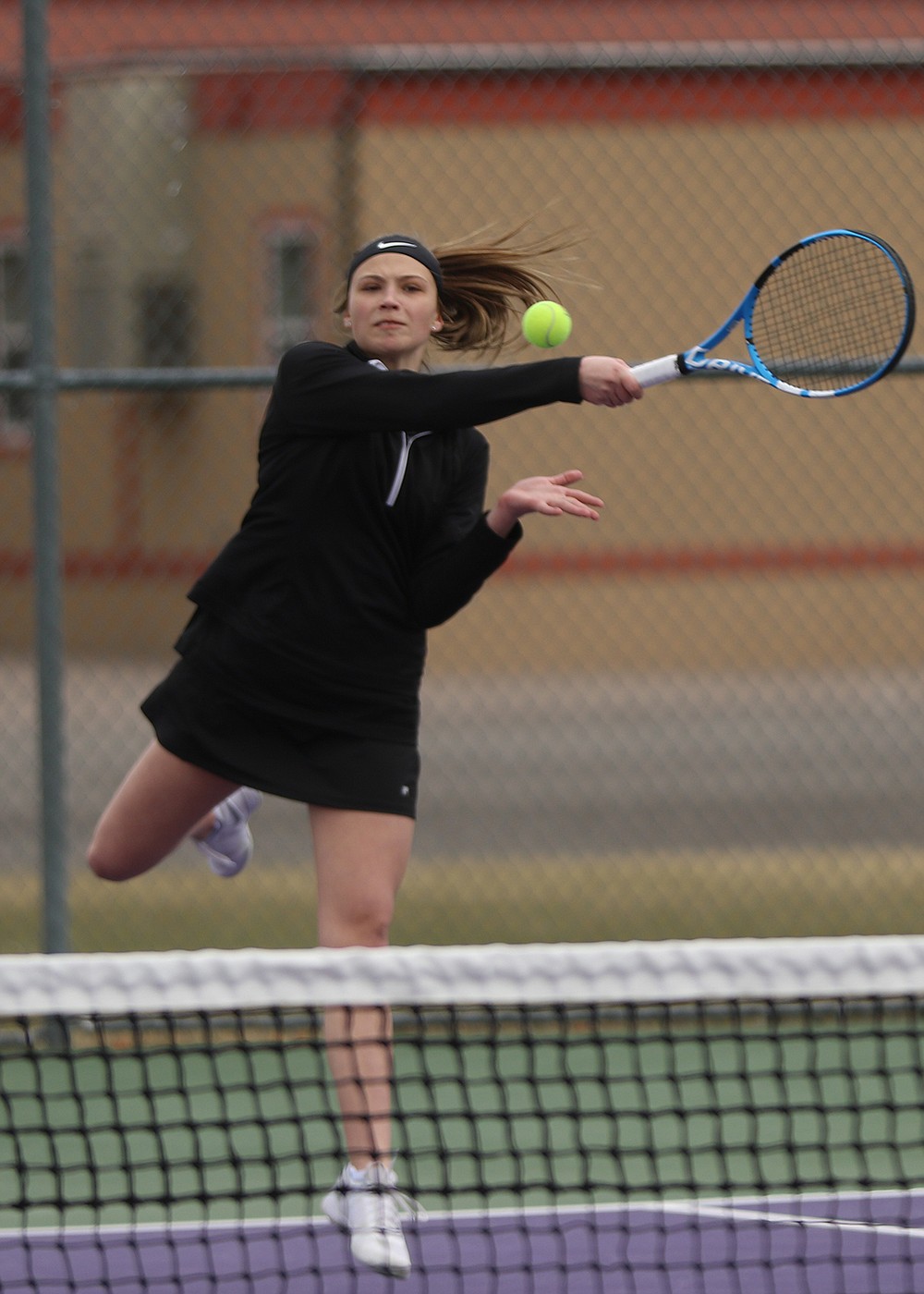 Liz Tolley hits a shot during her doubles match against Libby. (Courtesy of Bob Gunderson)