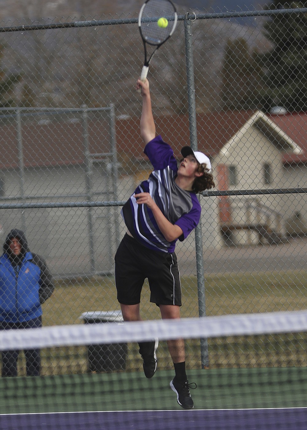 Michael Smith serves during his singles match against Libby's Ryker McElmurry. (Courtesy of Bob Gunderson)
