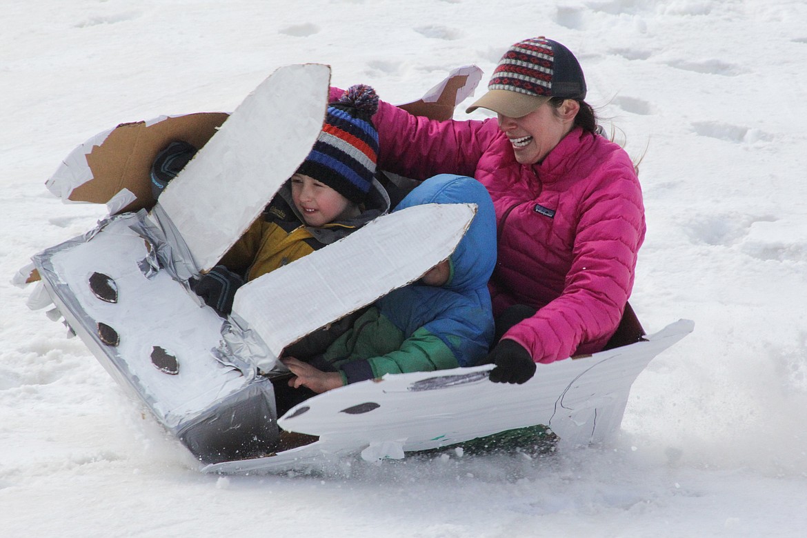 Tawny, Manny and Maxin ride their rabbit-themed toboggan.