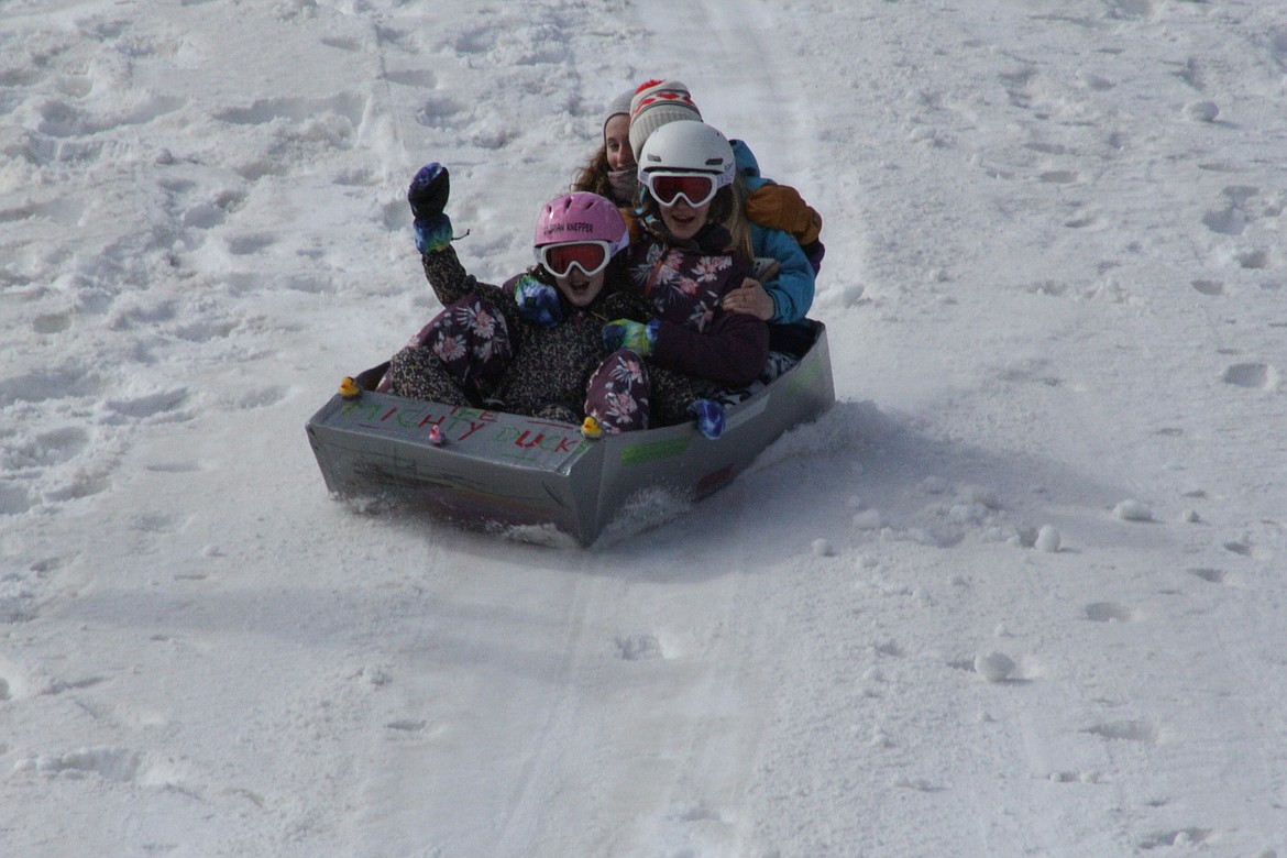 Brooklyn, Makia and Xadrian slide down the hill at Schweitzer Tuesday morning.