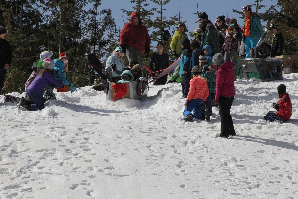 Students push off in their toboggan Tuesday morning at Schweitzer.