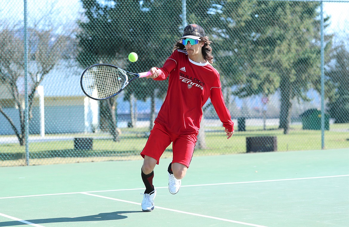 Aden Heitz chases down a ball and hits a return on Wednesday.