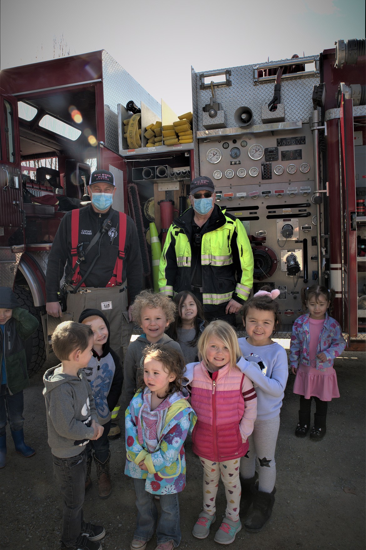 Students and firefighters from the Sam Owen Fire Department pose for a photo at Hope Preschool.