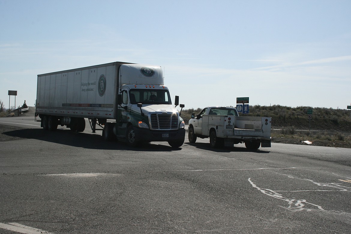 Trucks and cars negotiate Hansen Road in Moses Lake.