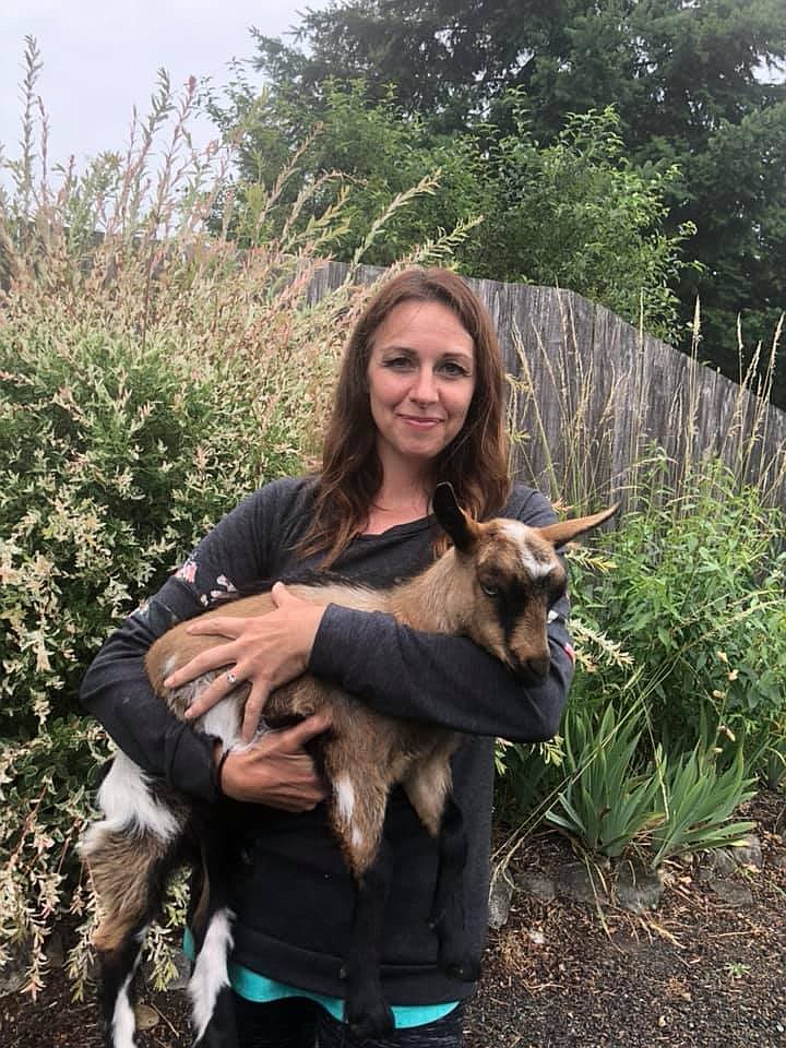 Heather Fitzhugh holds up one of her baby myotonic goats near her home in Royal City.