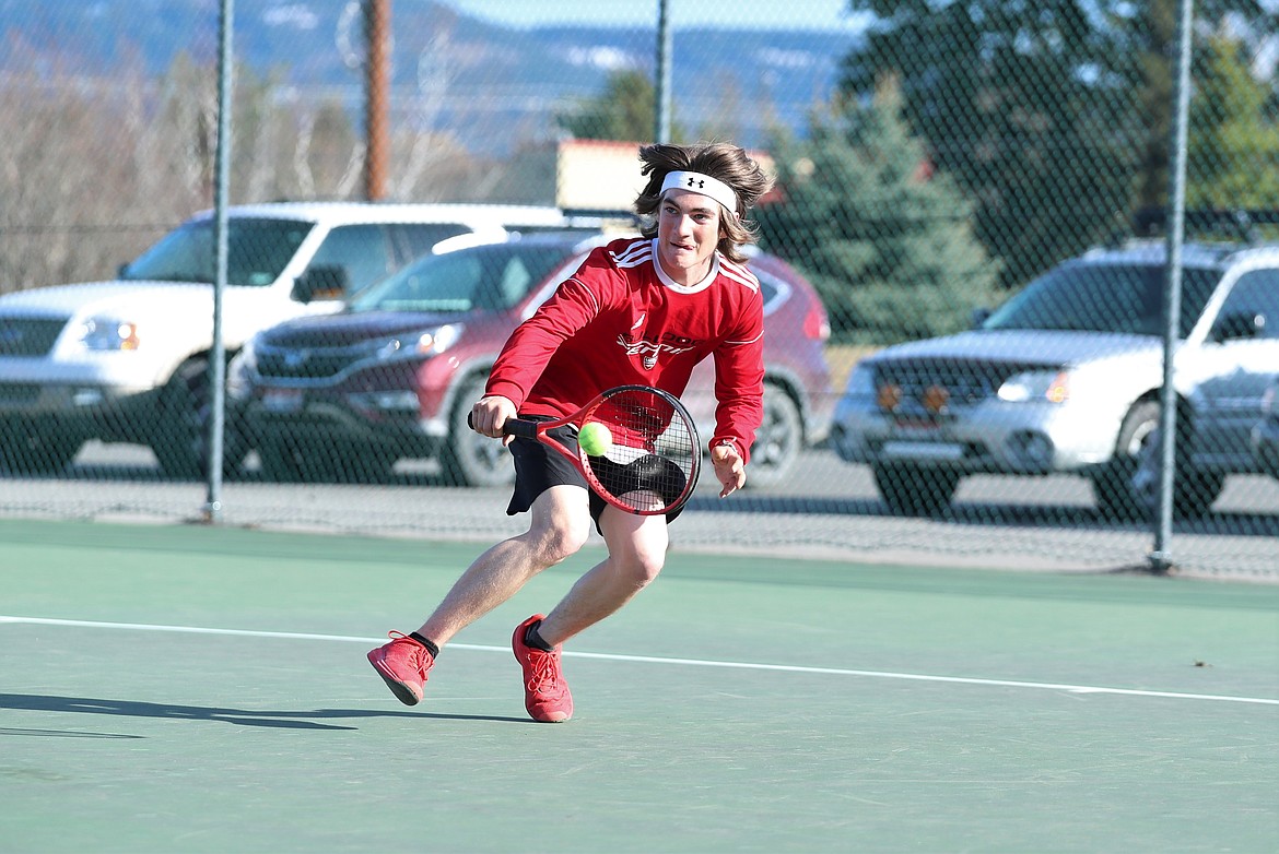 Tyler McNamee gets down low to return a backhand in singles play on Wednesday.