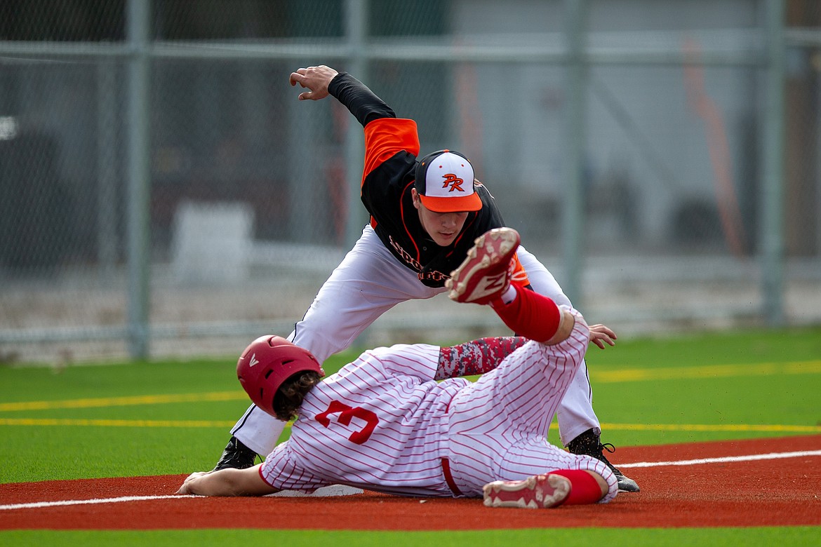 Priest River's Landon Reynolds tags Sandpoint's Trevor Brackett before he reaches third base on Thursday.