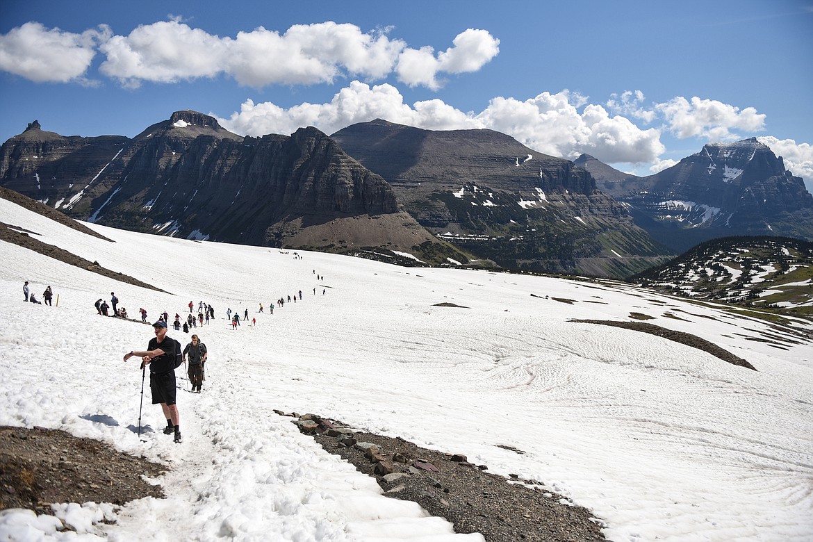Hikers ascend a snow-covered section of the Hidden Lake Trail in Glacier National Park on Wednesday, June 26, 2019. (Casey Kreider/Daily Inter Lake)