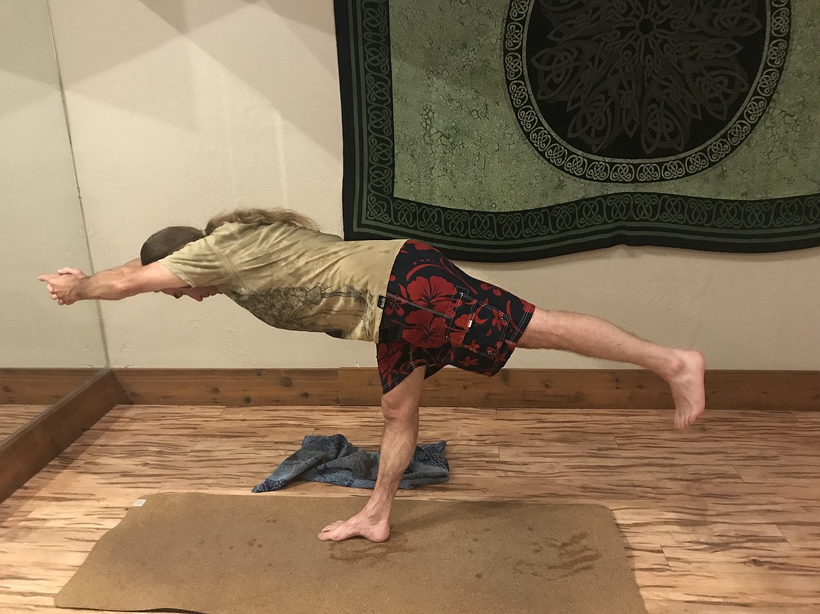 Mark Shearer, A hot yoga and gentle yoga instructor for the past two years practices at Sandpoint Hot Yoga in his hot practice.