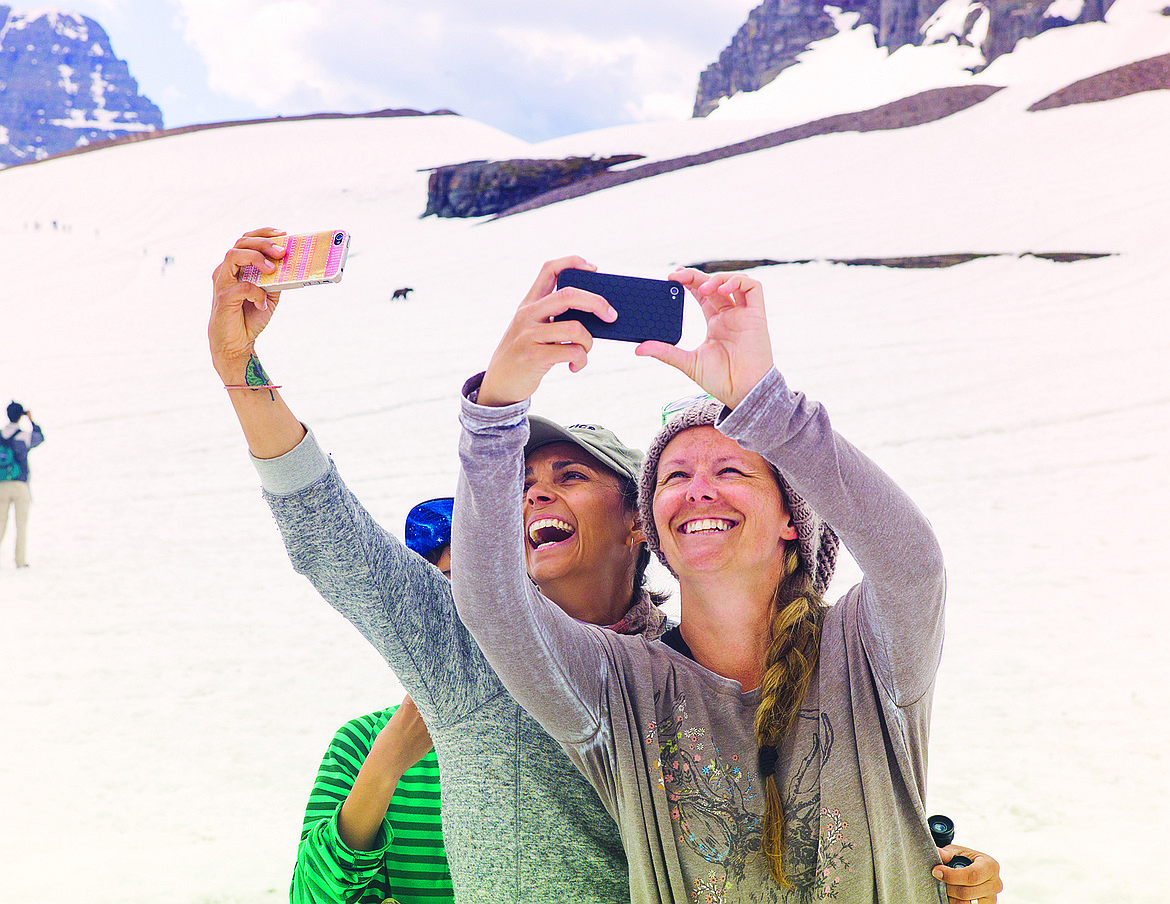 Two park visitors take a selfie near Logan Pass. (Chris Peterson/Hungry Horse News)