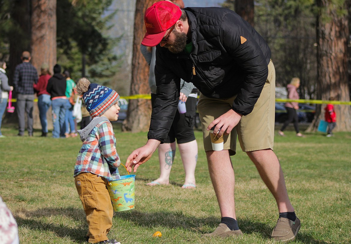 A father helps his son with the egg hunt Saturday at Lakeview Park.