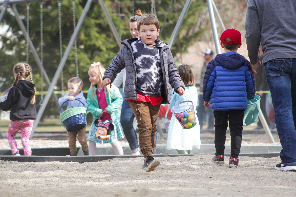 A boy runs to pick up eggs Saturday at the egg hunt.