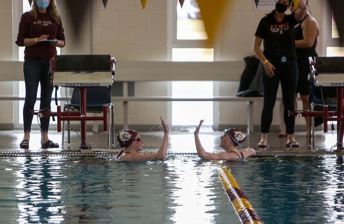 Left to right, teammates Laurel Knox and Makhaela Parrish celebrate after finishing first and second in the final heat of the 200 freestyle event at Moses Lake High School last Thursday.