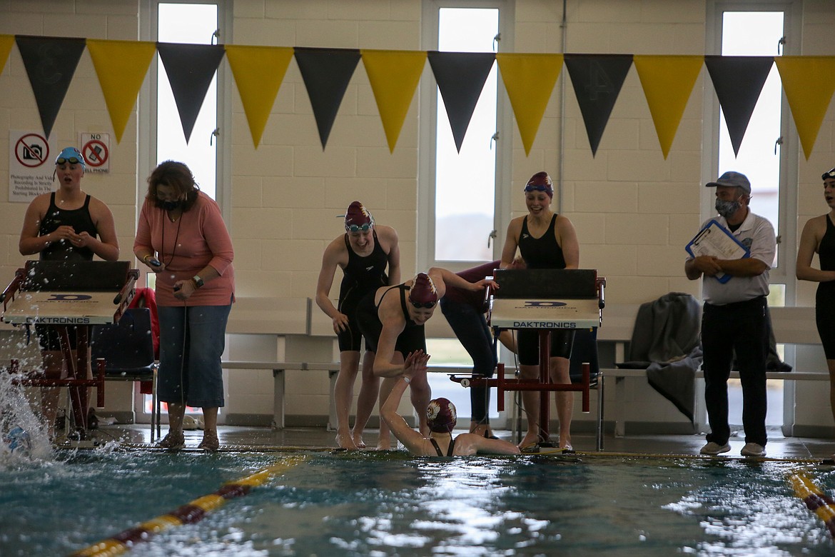 Moses Lake 200 Freestyle Relay team members celebrate together after setting a new school record by just tenths of a second on Thursday afternoon at MLHS.