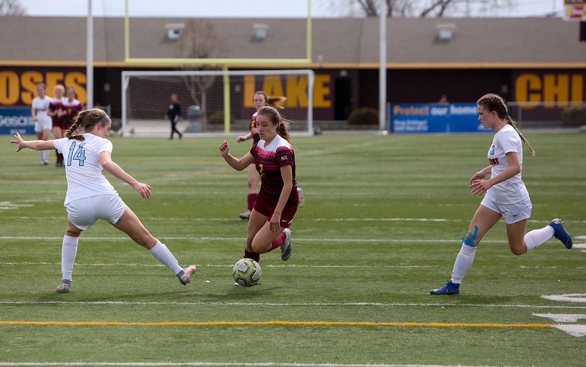 Natalie Bunch splits a pair of Eastmont defenders as she cuts up the field on Saturday afternoon in Moses Lake.