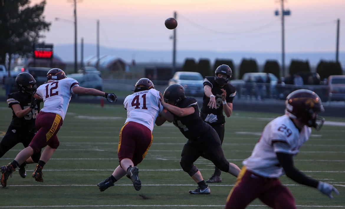 Royal's Caleb Christensen makes a pass downfield in the first half against Moses Lake on Friday night at RHS.