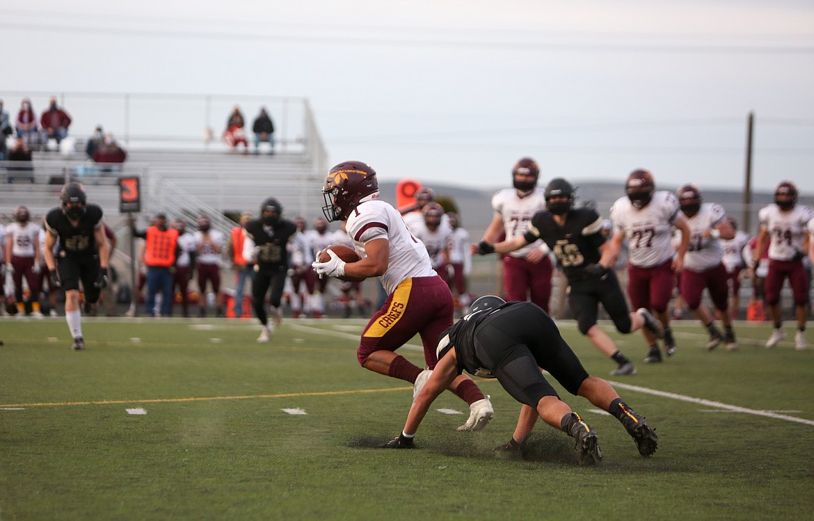 Moses Lake's Lerenz Thomas shakes off a defender as he makes a cut downfield against Royal in the first half on Friday night.