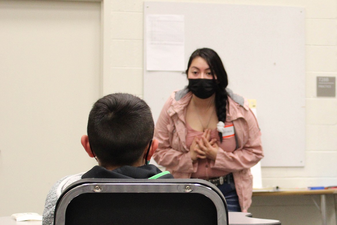 Facilitator Adriana Luna-Reyna gives a child participant a compliment for the Strengthening Families Program at Quincy Middle School on Friday.