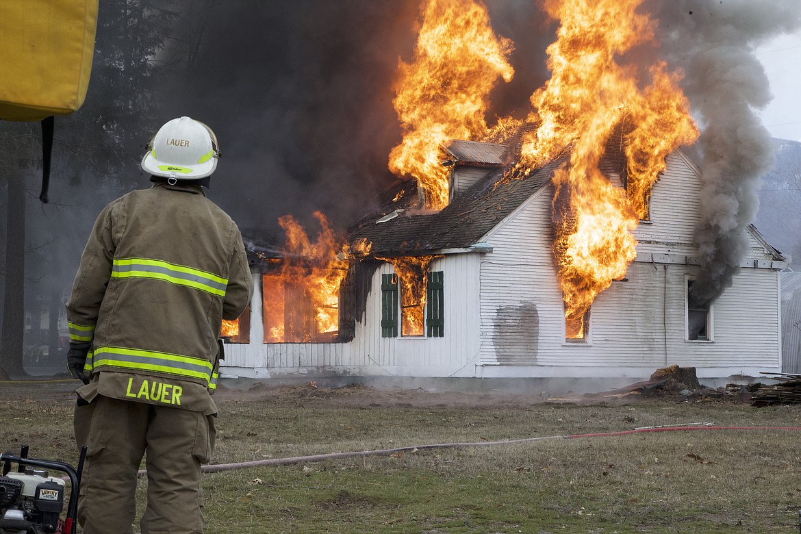 Steve Lauer, then assistant fire chief, supervises training exercises at a controlled house fire March 27. Firefighters with the Libby Volunteer Fire Department elected Lauer fire chief April  1. (Will Langhorne/The Western News)