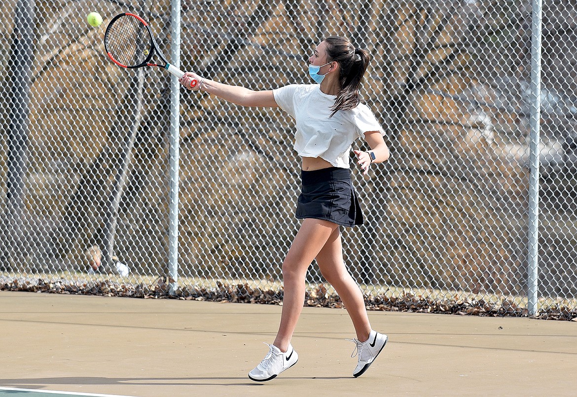 Lady Bulldog Alivia Lusko hits a shot during the high school girls tennis practice on Thursday. (Whitney England/Whitefish Pilot)