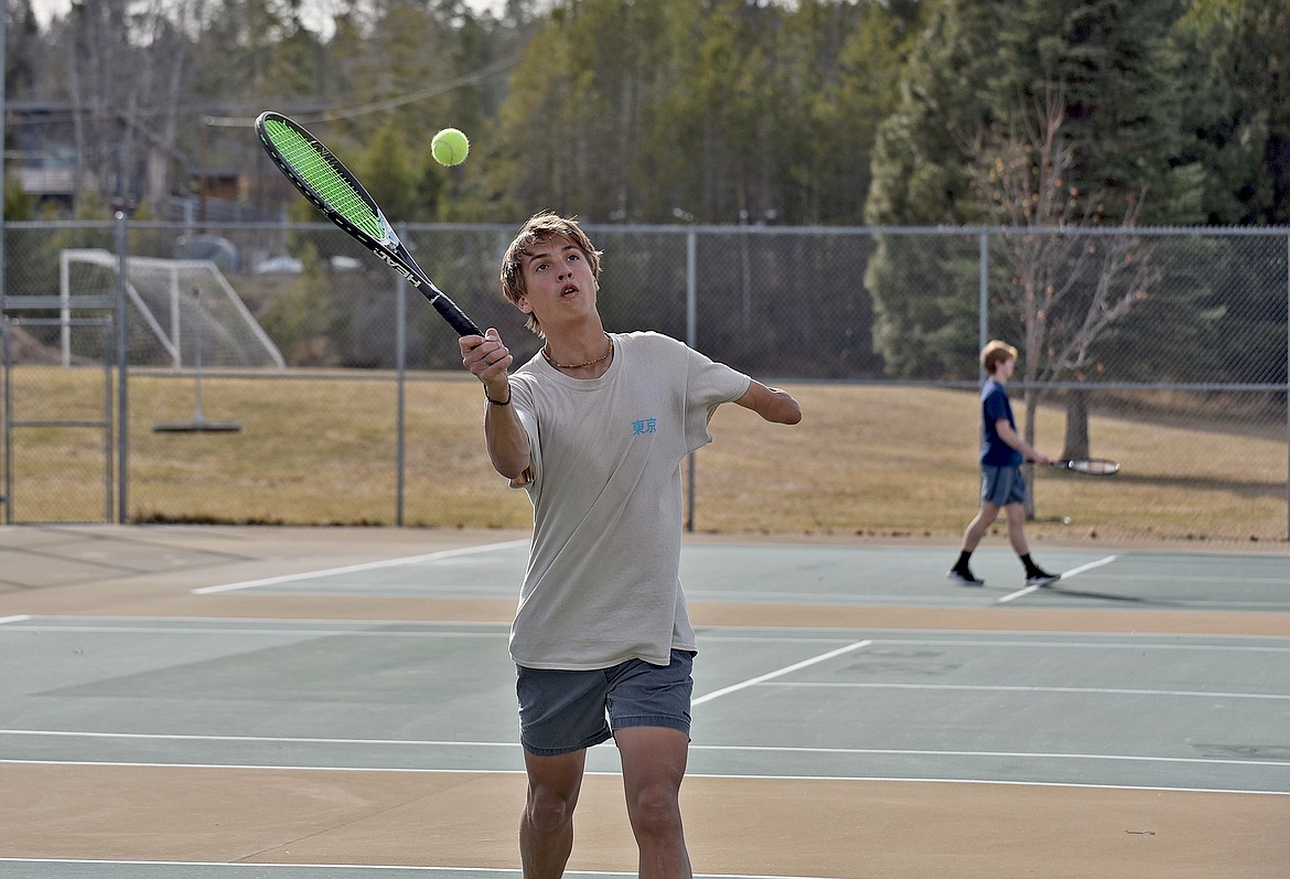 Whitefish's Joe Brandt lines up a volley during the high school boys tennis practice on Thursday. (Whitney England/Whitefish Pilot)