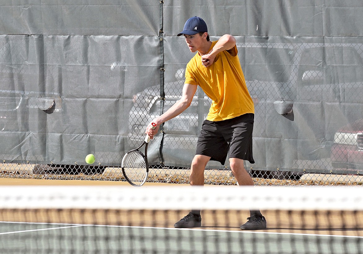 Bulldog Jack Robertson lines up a shot during the boys high school tennis practice on Thursday. (Whitney England/Whitefish Pilot)