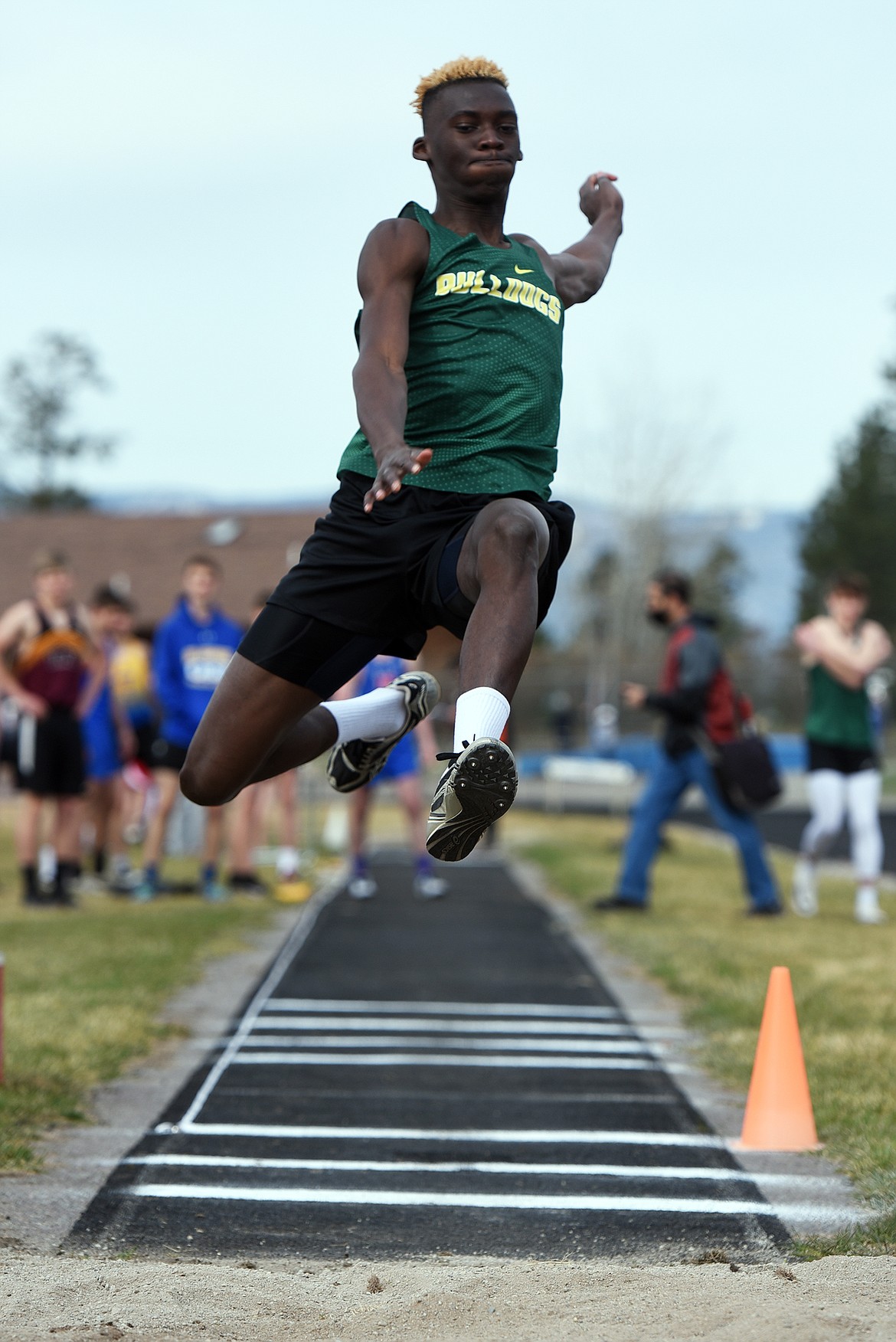 Bulldog Marvin Kimera flies to a fourth-place finish in the long jump at the Bigfork Invite track meet in Bigfork on Saturday. (Jeremy Weber/Daily Inter Lake)