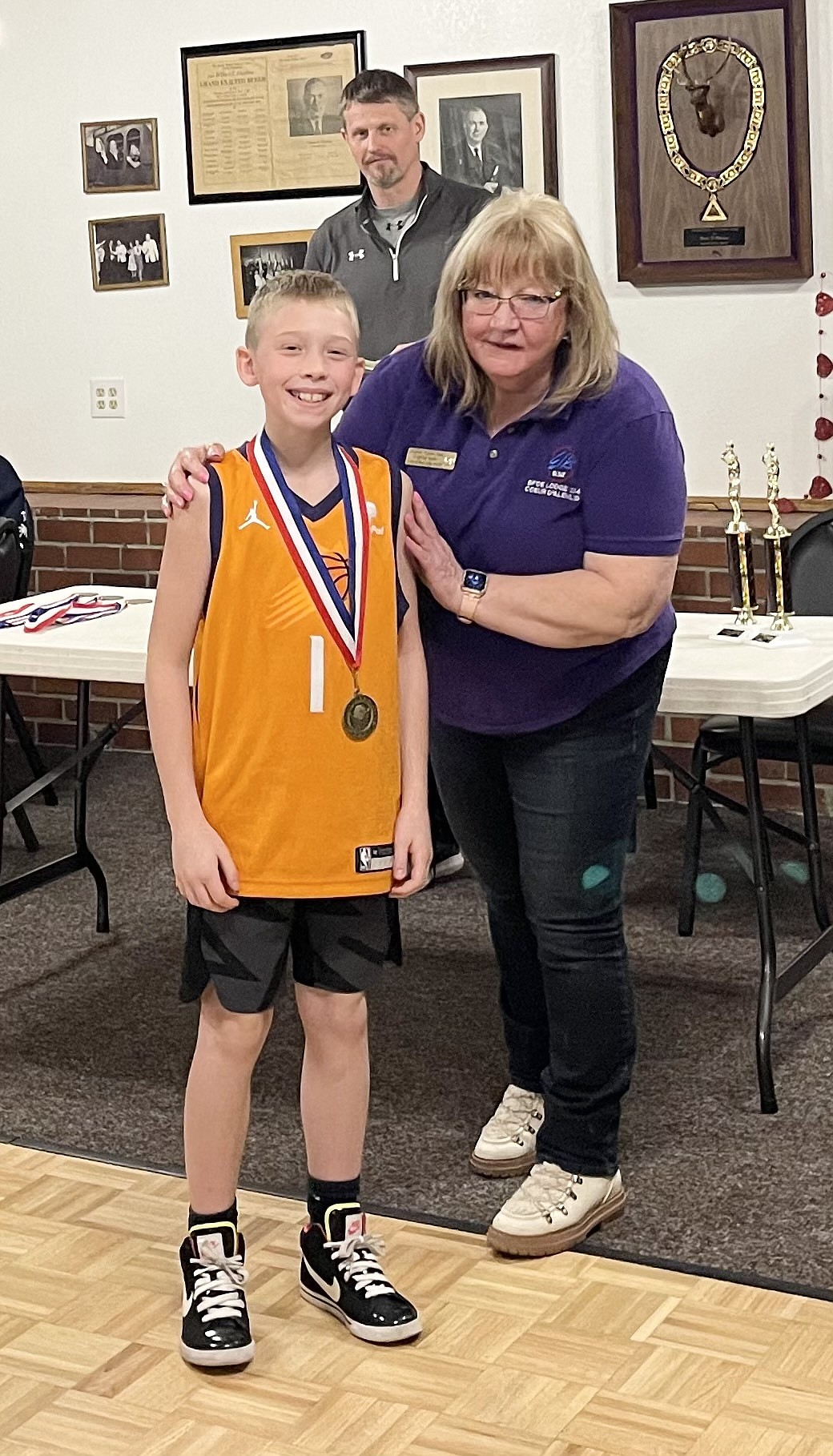 Courtesy photo
Maddox Hodges won the boys 10-11 age division at the Coeur d'Alene Elks Hoop Shoot held Feb. 20 at The Courts at Real Life in Post Falls. Also pictured is Debbi Nadrchal, Elks Exalted Ruler, and Todd Stoddard, Hoop Shoot director.