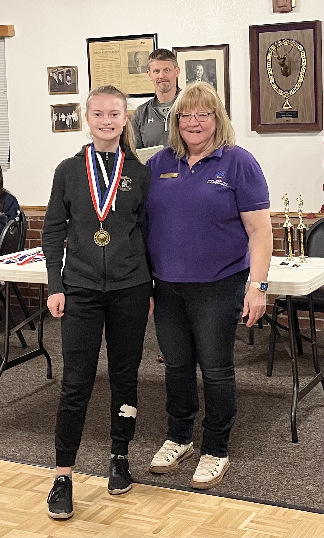 Courtesy photo
Malia Miller won the girls 12-13 age division at the Coeur d'Alene Elks Hoop Shoot held Feb. 20 at The Courts at Real Life in Post Falls. Also pictured is Debbi Nadrchal, Elks Exalted Ruler, and Todd Stoddard, Hoop Shoot director.