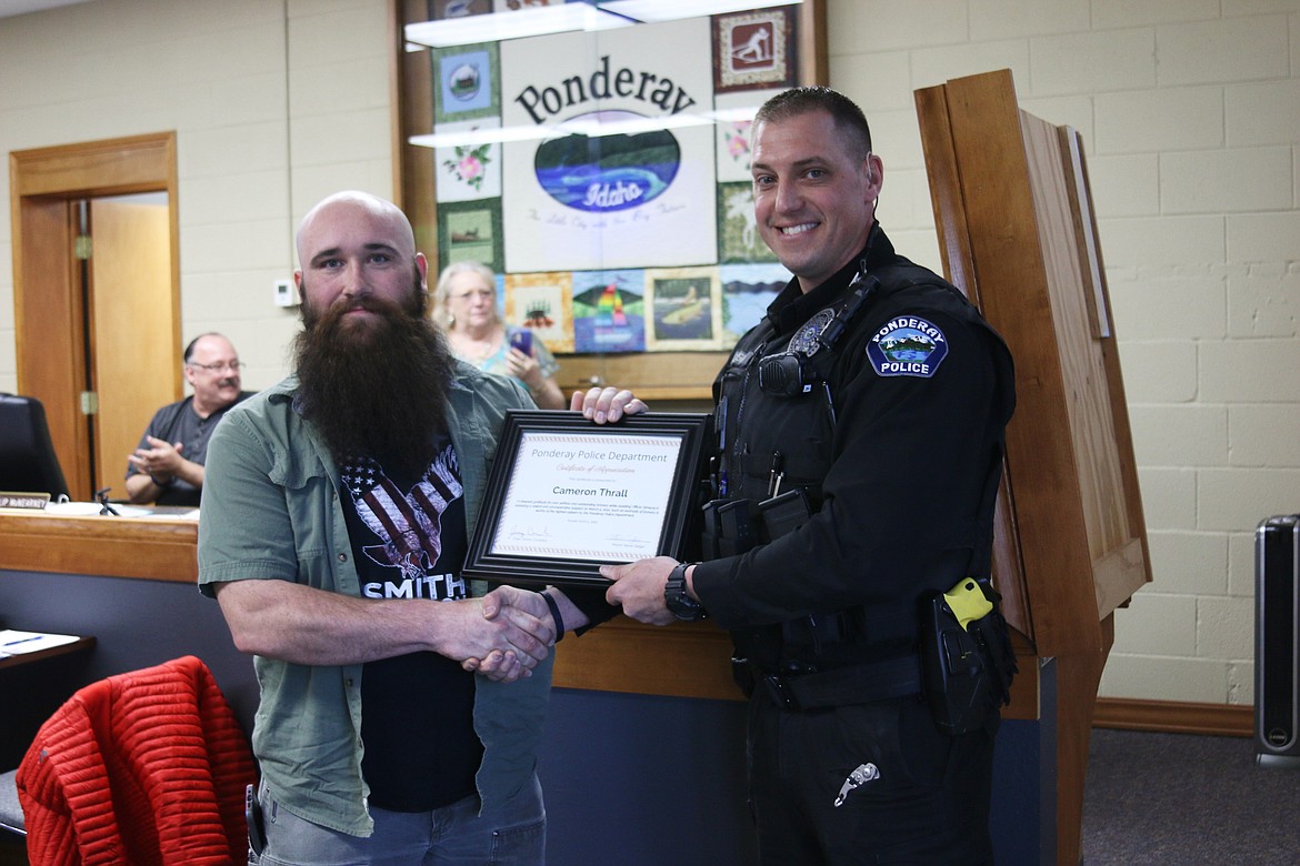 Officer Cameron Simeral awards a citizen commendation to Cameron Thrall in his efforts to Simeral in making an arrest with a man who was resisting and verbally agressive.
